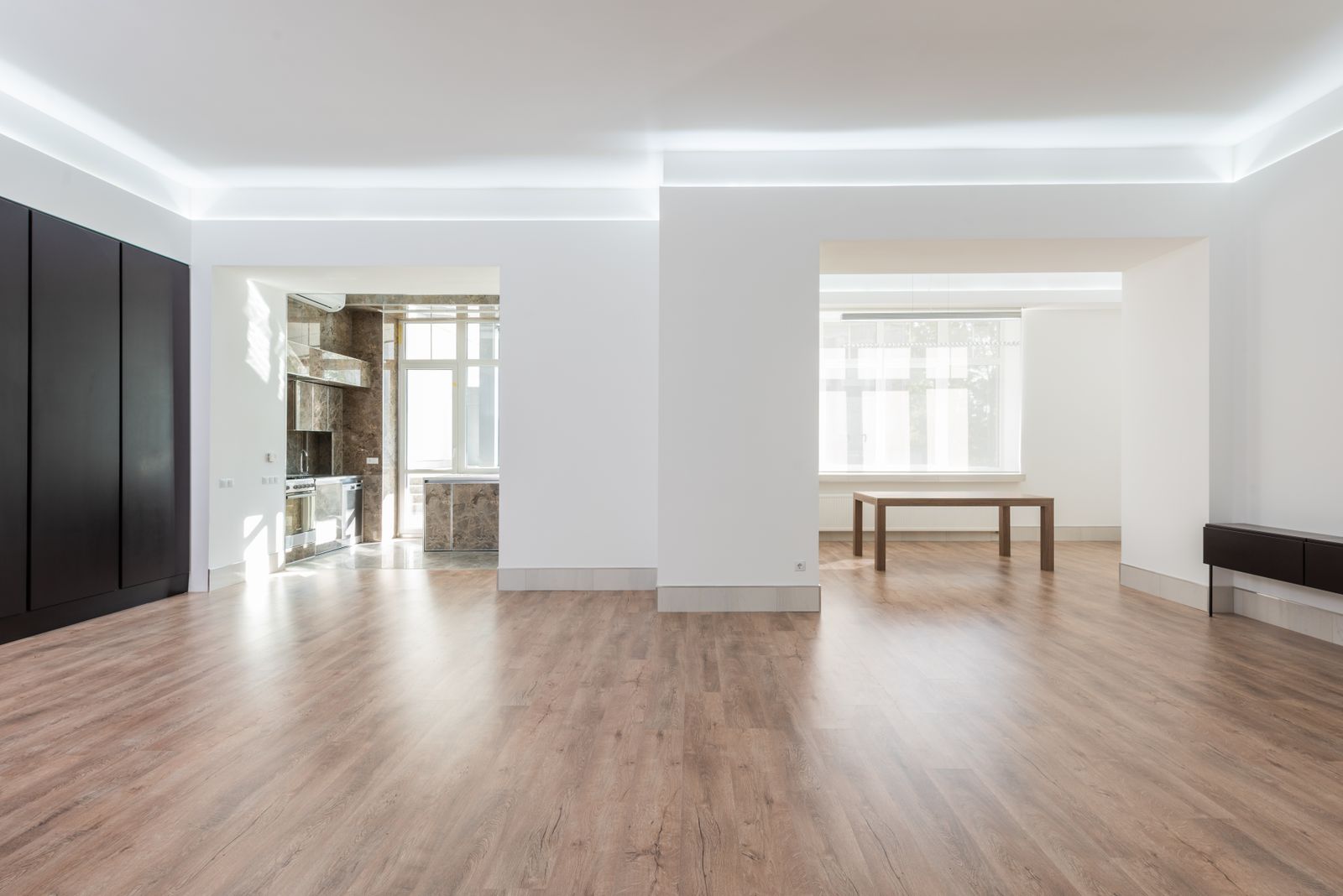Plank flooring being installed over a prepared concrete slab